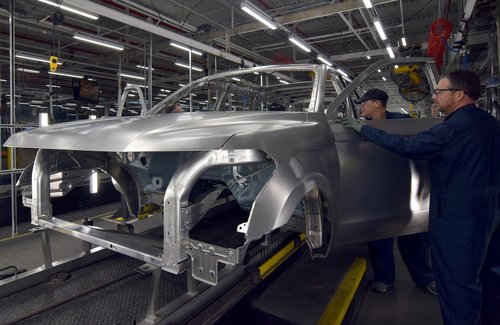 FILE PHOTO: Ford workers Mark Hunter and Robbie Marvin inspect the body of a Ford Expedition SUV at FordÕs Kentucky Truck Plant in Louisville