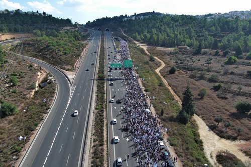 Family members, friends and supporters of Israelis and other nationalities who were taken hostage on October 7 by Palestinian Islamist group Hamas gunmen during a deadly attack, march towards Jerusalem