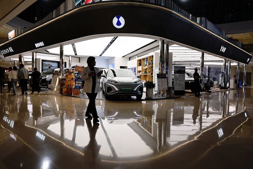 Electric vehicle (EV) models are displayed at the booth of Denza, a joint venture between Mercedes-Benz Group AG and BYD Auto, in Beijing