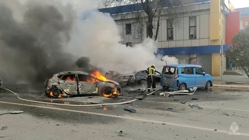 Firefighters extinguish a burning car following shelling in Belgorod