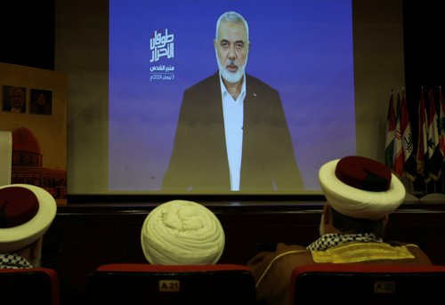 Hamas chief Ismail Haniyeh speaks in a pre-recorded message shown on a screen during an event ahead of al-Quds, in Beirut