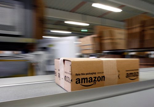 FILE PHOTO: A parcel moves on the conveyor belt at Amazon's logistics centre in Graben