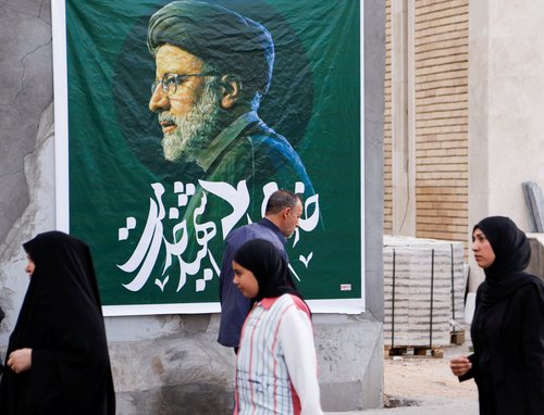 People walk outside the Iranian embassy after the deaths of Iran's President Ebrahim Raisi and others, in Baghdad
