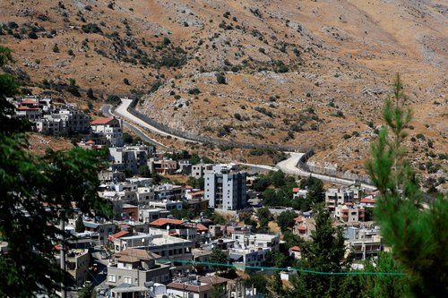golanska visoravan, A view of Majdal Shams, a Druze village where children and teens were killed at a soccer pitch by a rocket Israel says was fired from Lebanon, in the Israeli-occupied Golan Heights
