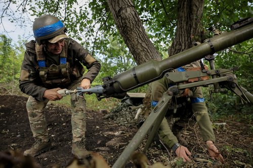 Ukrainian servicemen fire a SPG-9 anti-tank grenade launcher towards Russian troops at a frontline near the town of Chasiv Yar