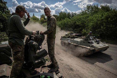 FILE PHOTO: Ukrainian service members ride an Armoured Personnel Carrier near the Russian border in Sumy region