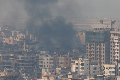 Smoke billows over Beirut's southern suburbs, as seen from Sin El Fil