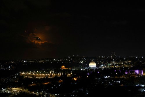 The Dome of the Rock on the Al-Aqsa compound, also known to Jews as the Temple Mount is seen as projectiles fly through the sky, after Iran fired a salvo of ballistic missiles at Israel, as seen from Jerusalem