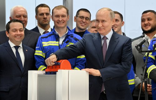FILE PHOTO: Russian President Putin launches the first natural gas liquefaction line on a gravity-type base for the Arctic LNG-2 project in Murmansk region