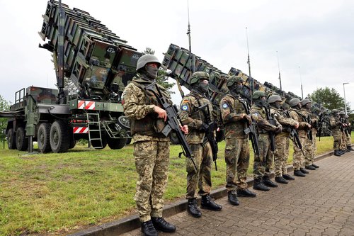 Soldiers stand during Ukrainian President Volodymyr Zelenskiy's visit to a military