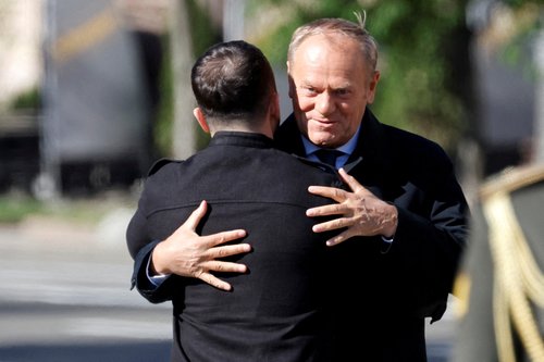 FILE PHOTO: Ukraine's President Volodymyr Zelenskiy greets Poland's Prime Minister Donald Tusk