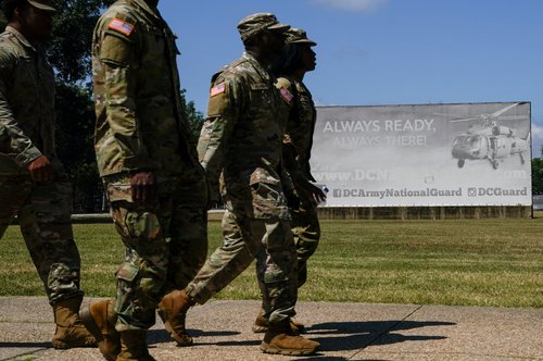 U.S. military personnel walk outside the D.C. Armory after U.S. President Donald Trump's announcement to deploy the National Guard and federalize the Metropolitan Police Department in Washington, D.C., U.S., August 12, 2025. REUTERS/Elizabeth Frantz