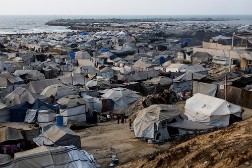 Palestinians, displaced by the Israeli offensive, shelter in a tent camp on a beach amid summer heat in Gaza City, August 12, 2025. REUTERS/Mahmoud Issa