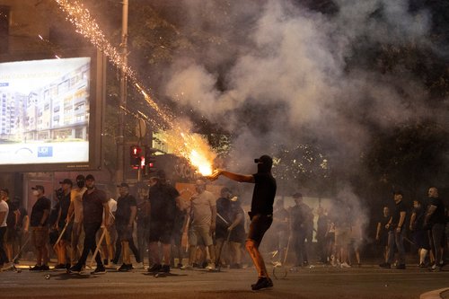 A person fires fireworks, during a standoff between supporters of the ruling party and anti-government protesters in Belgrade, Serbia, August 14, 2025. REUTERS/Djordje Kojadinovic TPX IMAGES OF THE DAY