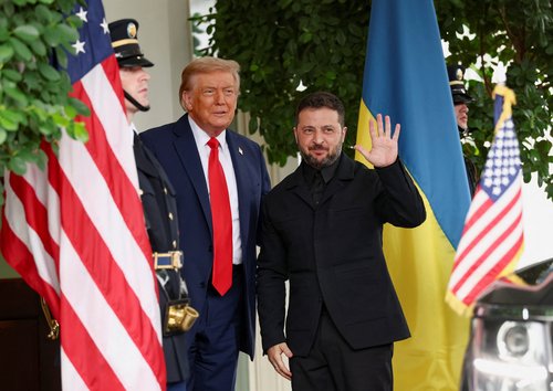 Ukrainian President Volodymyr Zelenskiy waves as he meets U.S. President Donald Trump at the White House