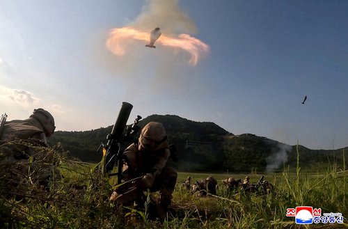 Members of the tactical artillery units under the large combined units of the Korean People's Army take part in a shooting training competition at an unknown location in this handout image released on August 12, 2025.