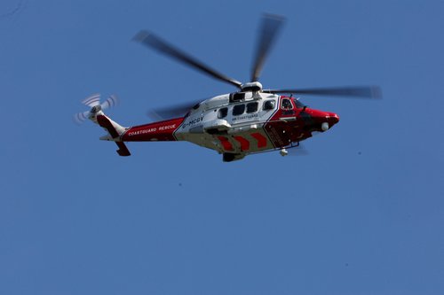 A coastguard helicopter flies over Prestwick Glasgow Airport, on the day JD Vance leaves Scotland after his holiday, in Prestwick, Scotland, Britain, August 17, 2025. R
