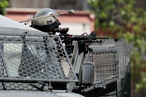 A member of the Israeli forces holds a gun, during an Israeli raid in Ramallah, in the Israeli-occupied West Bank, August 26, 2025.