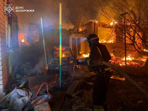 A firefighter works at the site of an apartment building hit during a Russian drone and missile strike