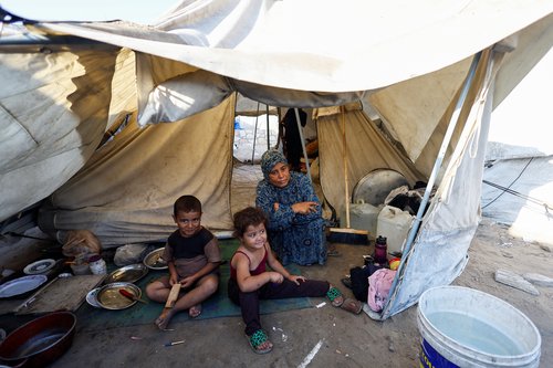 Palestinians displaced by the Israeli military offensive take shelter in a tent camp, as Israeli forces escalate operations around Gaza City