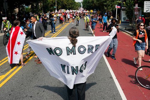A demonstrator holds a banner during the "We Are All D.C." march to protest against National Guard troops in Washington, D.C., U.S., September 6, 2025.