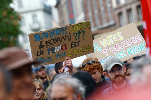 A protester holds a placard which reads ""Barnier, Bayrou, Lecornu ??? France is cuckolded three times over" during a demonstration in Strasbourg