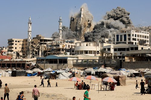 Smoke rises from the evacuated Al-Ghefari tower, as it collapses after it was hit by Israeli air strikes, in Gaza City