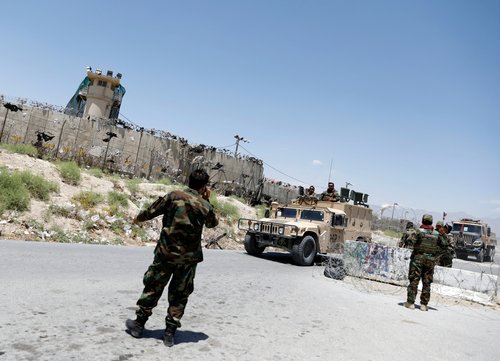 FILE PHOTO: Afghan soldiers stand guard at a checkpoint outside the U.S Bagram air base, on the day the last of American troops vacated it, Parwan province, Afghanistan July 2, 2021.REUTERS/Mohammad Ismail/File Photo