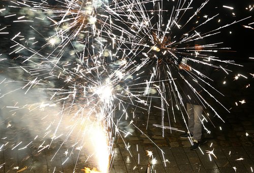 A person uses a smartphone as fireworks explode to mark the New Year's celebrations in central Berlin, Germany, January 1, 2026.REUTERS/Lisi Niesner
