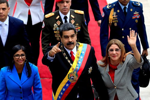 Venezuela's President Nicolas Maduro, flanked by his wife Cilia Flores and National Constituent Assembly President Delcy Rodriguez, arrives for a special session of the National Constituent Assembly