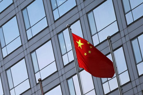 FILE PHOTO: A Chinese flag flutters outside the China Securities Regulatory Commission (CSRC) building on the Financial Street in Beijing, China February 8, 2024.