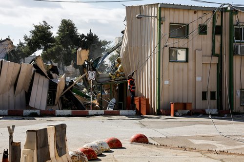 A man handles fallen cables at the Jerusalem headquarters of the United Nations Relief and Works Agency for Palestine Refugees (UNRWA) as the headquarters is dismantled by Israeli forces, in East Jerusalem, January 20, 2026.