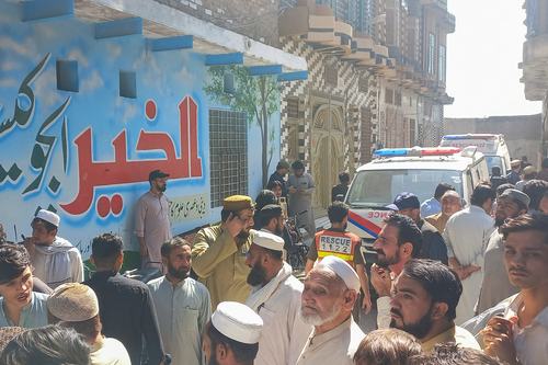Parents and residents gather near an ambulance after a school roof collapse in Peshawar, Pakistan, October 15, 2026. Picture taken with a mobile phone. REUTERS