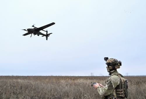 A serviceman of the National Police Special Purpose Battalion Zaporizhzhia region controls a Gara reconnaissance and strike drone while they work at a position near a front line, amid Russia's attack on Ukraine