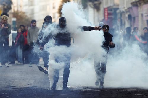 Demonstrators react amid tear gas, the day after a national day of demonstrations against the cost of living and rising fuel prices, in Paris, France, October 18, 2026. REUTERS/Abdul Saboor