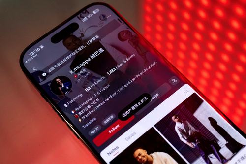 A smartphone displays the account of French soccer player Kylian Mbappe. REUTERS/Maxim Shemetov/Illustration