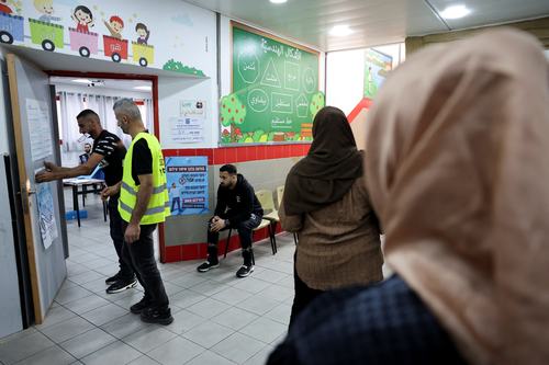 Voters wait outside a voting room. REUTERS/Ammar Awad