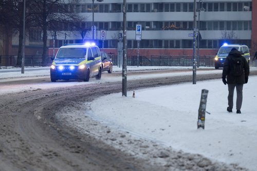Police patrol cars drive along snow-covered roads in Berlin, Germany, February 5, 2026. REUTERS/Axel Schmidt