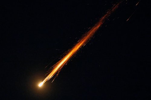 A fragment of a projectile falls from the sky following an interception of an Israeli anti-air defence system, after missiles were launched towards Israel from Iran