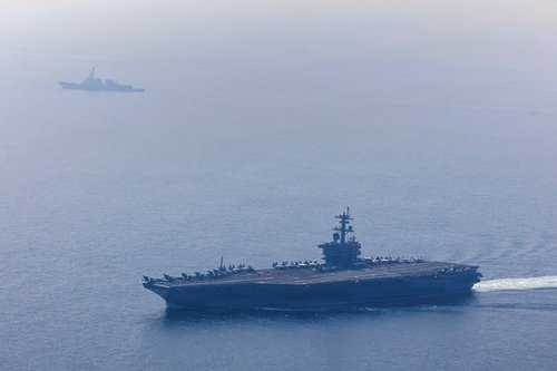 The U.S. Navy's Nimitz-class aircraft carrier USS Abraham Lincoln and Arleigh Burke-class guided-missile destroyer USS Frank E. Petersen Jr. sail