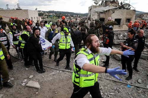 Emergency personnel carry a body at the site of an Iranian strike, after Iran launched missile barrages following attacks by the U.S. and Israel on Saturday, in Beit Shemesh, Israel March 1, 2026.