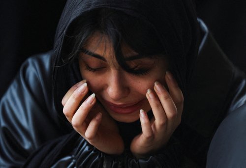 Mourners react as they attend a funeral ceremony for victims of Israeli and U.S. strikes, amid the U.S.-Israeli conflict with Iran