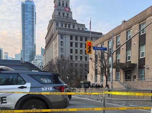Law enforcement personnel survey the scene outside the U.S. Consulate after shots were fired, in Toronto, Ontario, Canada, March 10, 2026. Picture taken with a mobile phone. REUTERS/Kyaw Soe Oo
