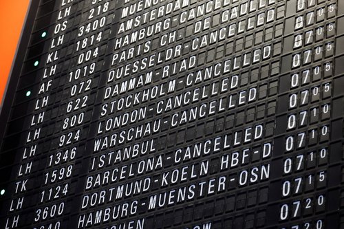 A board displays information on cancelled flights, as German air carrier Lufthansa's pilots go on a two-day strike