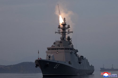 The Choe Hyon naval destroyer conducts a missile test launch observed by North Korean leader Kim Jong Un at an unknown location in North Kore