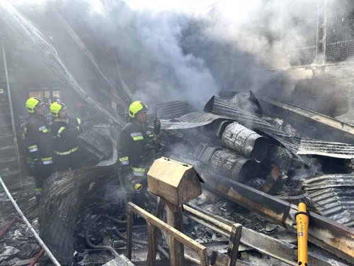 Rescue forces work at the site of an Iranian army helicopter crash in a fruit market in Isfahan, Iran, February 24, 2026.