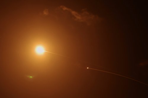 Streaks of light illuminate the sky during an interception attempt amid the U.S.-Israeli conflict with Iran, as seen from Tel Aviv, Israel March 15, 2026. REUTERS/Tyrone Siu