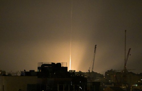 The sky is illuminated as an Iranian missile lands in Israel, amid the U.S.-Israeli conflict with Iran, as seen from Tel Aviv, Israel, March 12, 2026.