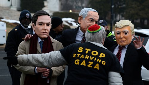 Demonstrators wearing masks depicting U.S. Secretary of State Marco Rubio, Israeli Prime Minister Benjamin Netanyahu, and U.S. President Donald Trump take part in a protest near U.S. Institute of Peace building