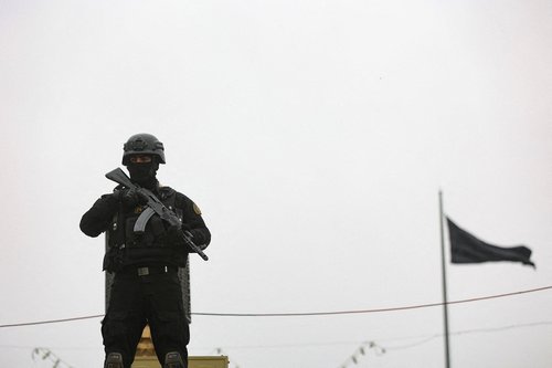 A security personnel stands guard as Iranians take part in a protest marking the annual al-Quds Day (Jerusalem Day) on the last Friday of the holy month of Ramadan, amid the U.S.-Israeli conflict with Iran, in Tehran, Iran, March 13, 2026.